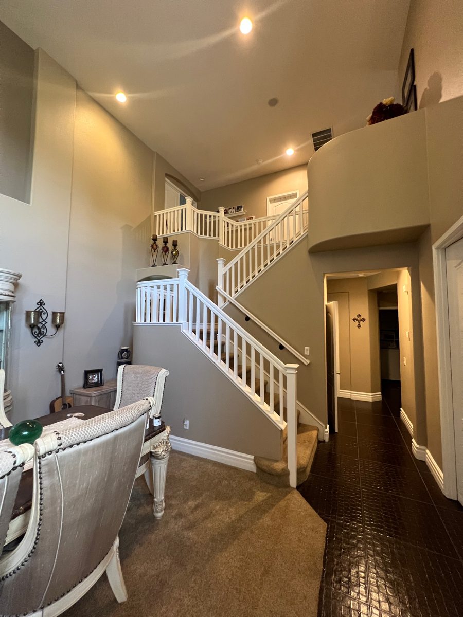 Living room with white stair railing and freshly painted walls
