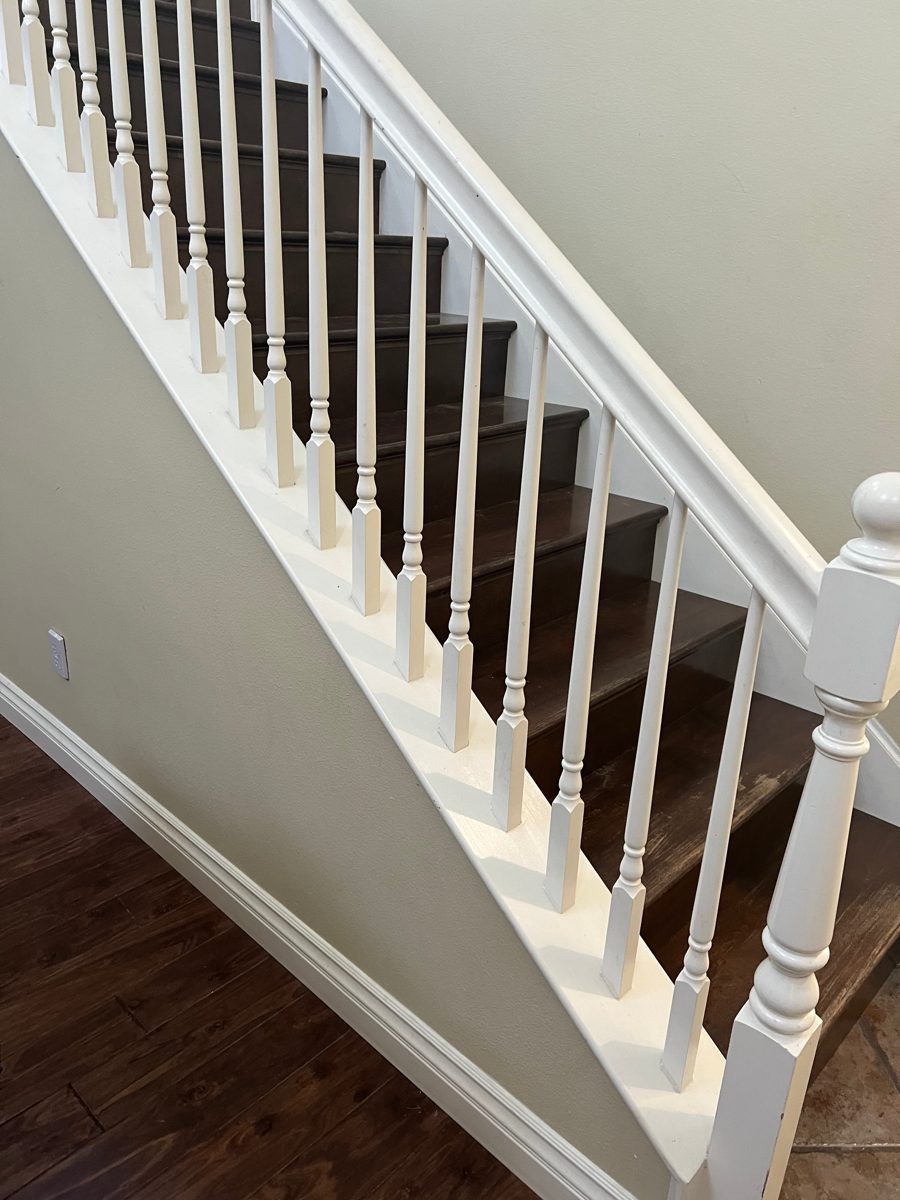 White staircase railing with crisp lines against fresh walls