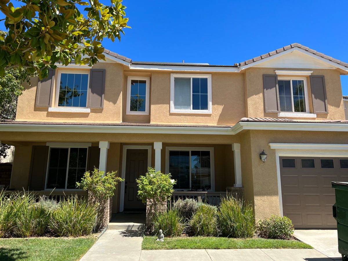 Two-story home exterior freshly painted in warm tones