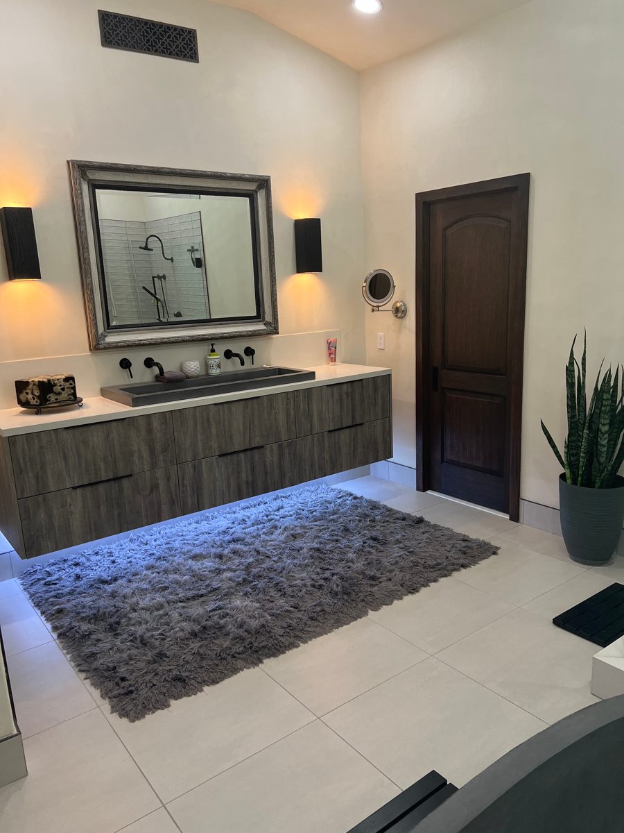 Bathroom vanity with dark wood doors and fresh wall paint